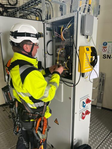 an offshore worker installing a Communications system