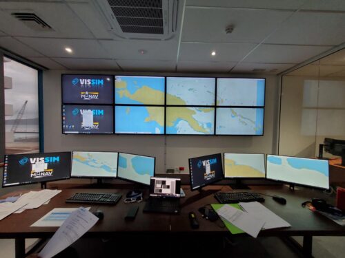 a view of a control system with several screens with vessel charts